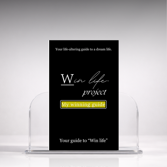Black eBook titled 'My Winning Guide' from the 'Win Life Project' in a professional hero photo on a stand with a white background. A 20 page blueprint on what winning truly means, and how to win life holistically, on your own authentic terms.